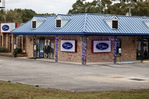Lil' John's brick storefront with blue roof and original oval signs