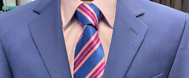 Blue suit with pink shirt and striped tie from Lil' John's